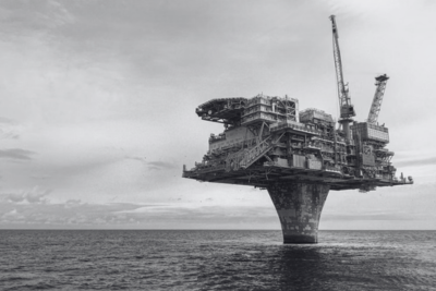 An offshore oil platform standing on a single column in open sea