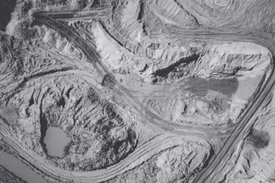 Aerial view of haul roads and terraced spoil in an open-pit mine