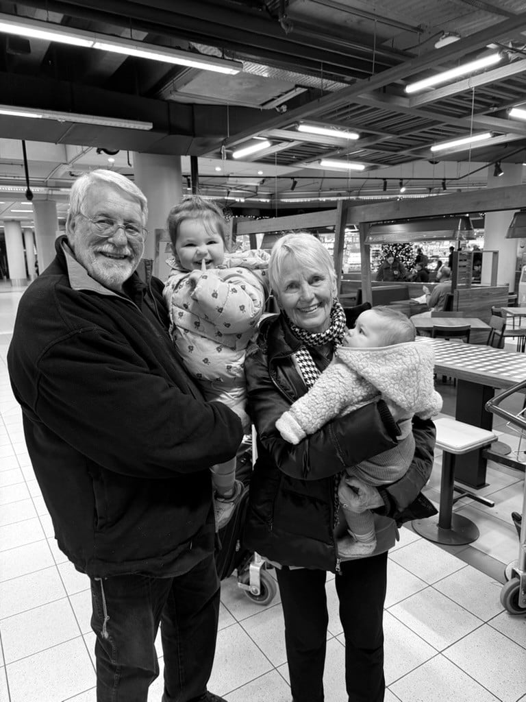Grandparents holding their two granddaughters
