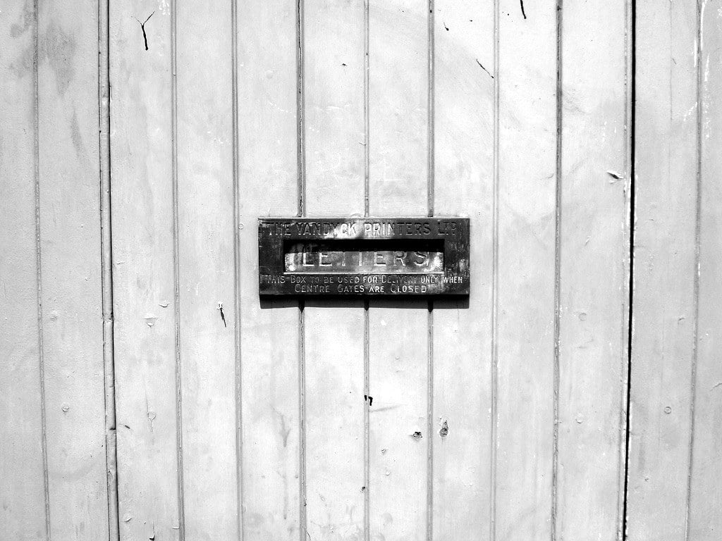 Brass letters slot in a wooden front door